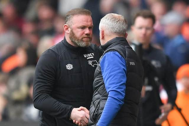 Rooney shakes hands with Neil Critchley