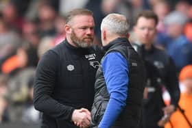 Rooney shakes hands with Neil Critchley