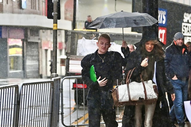 Tennis and TV star Annabel Croft gets a helping hand in the Lancashire rain.