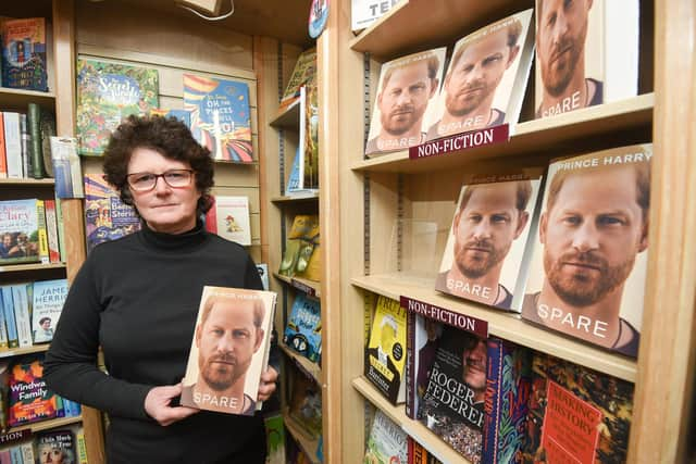 Spare, an autobiography by Prince Harry, on sale at Book, Bean and Ice Cream in Kirkham. Pictured is owner Elaine Silverwood.