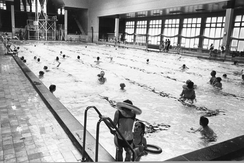 The huge pool being enjoyed by people in 1980