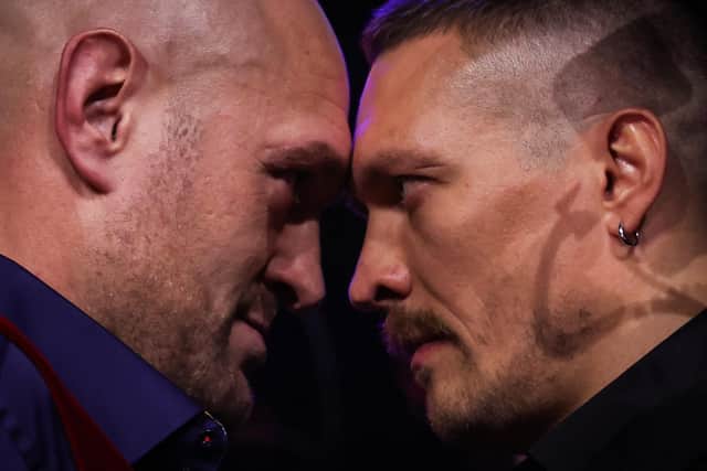 Britain's Tyson Fury (L) and Ukraine's Oleksandr Usyk (R) face off during a press conference.