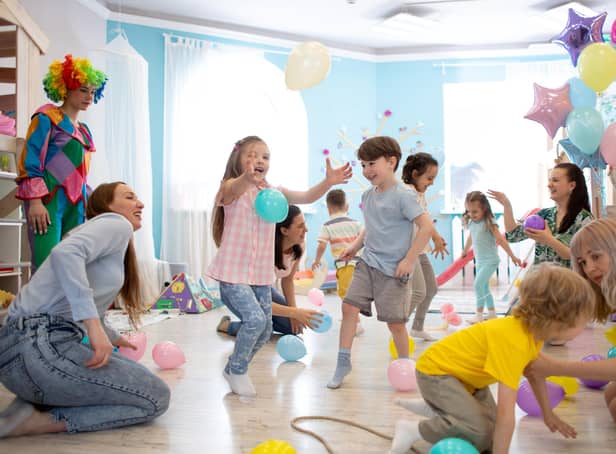 Children and their parents entertain and have fun with balloons
