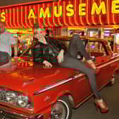 US cars and hot rods on the forecourt of Harts Amusements at Bispham. Russ Larcome (left) of UK Wheels Events and Charles Hart (Harts Amusements) with Russ's 1963 Ford Fairlane 500 and model Stacey Bradley from Cleveleys