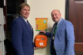 Coun Thomas Threlfall, chairman of Fylde Council's Environmental, Health and Housing Committee vice-chairman Coun Chris Dixon inspect the new defibrillator in the Town Hall reception area.