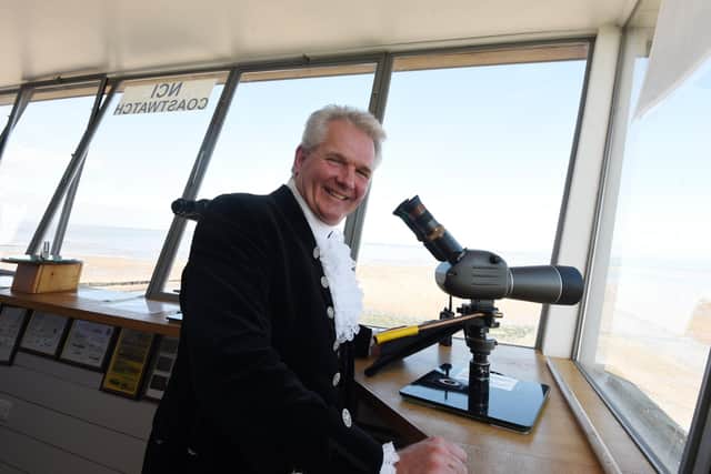 The High Sheriff of Lancashire Martin Ainscough  takes a look at the telescope at Rossall Point Watch Tower and learns about the National Coastwatch Institution before presenting certificates for service awards to volunteers.