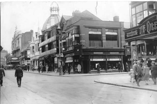 Church street junction of Coronation Street. The shop right of centre is Barkers and is advertising 'holiday wear' at the top of its windows. It was replaced in 1938 by Littlewoods. The white building is the Adelphi Hotel and to the right of the hotel is Taylors chemist