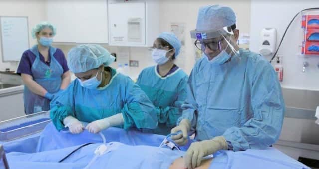 Professor Mohammed Munavvar (far right) and his team at work under the watchful eye of a worldwide medical audience [image: Lancashire Teaching Hospitals]