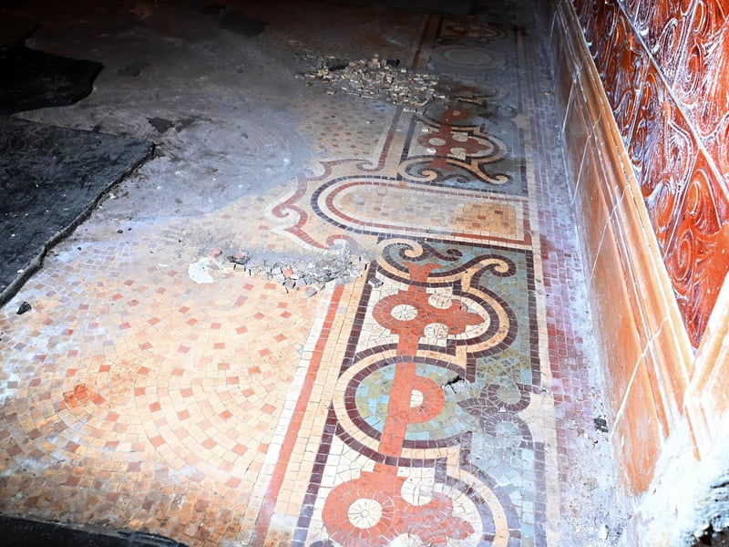 Still a work in progress, thick flooring has also been chipped away to reveal intricate mosaic flooring