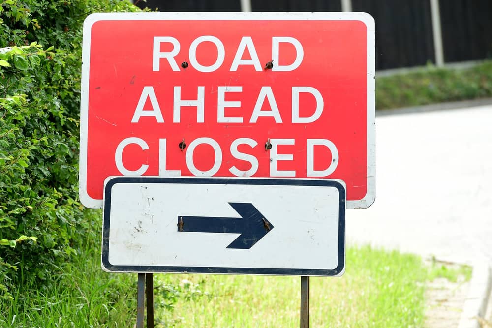 General view of a road ahead closed sign.