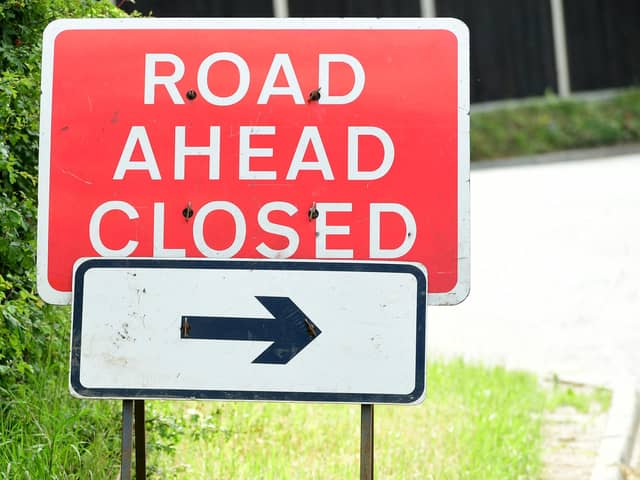 General view of a road ahead closed sign.
