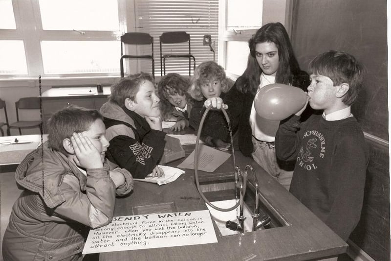 Anchorsholme Primary School pupils visit Blackpool and Fylde College. Stephen Morgan blows up a balloon to bend water by electrostatics, watched by, from left: Chris Barnes, David Johnson, Catherine Esler, Leanne Turnbull and student Ashley Walker
