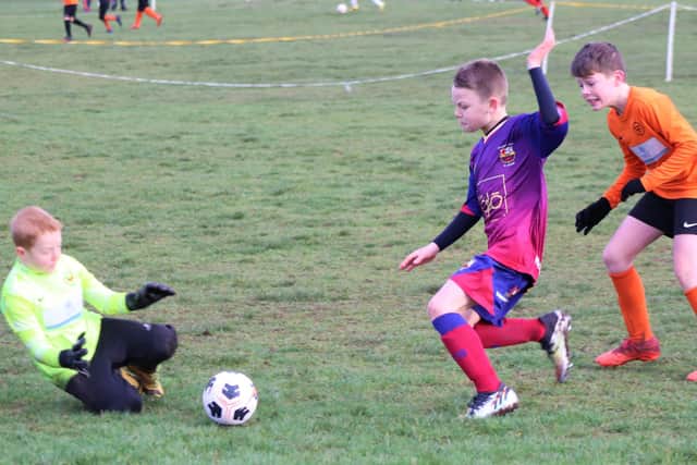 Match action between YMCA Orange Under-10 and Fylde Coast Soccer Messis
