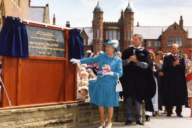 The Queen unveils a plaque outside the school hall with headmaster Richard Rhodes, 1994