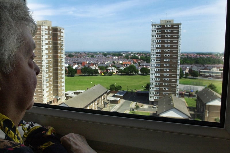 A resident of Walter Robinson Court looks out over Queenstown flats, Blackpool