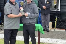 Autumn Waterloo champion Paul Dudley (right) receives the trophy from Waterloo bowls manager Mark Mills