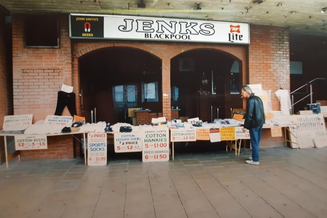 Trestle tables outside Jenks Bar selling cotton hankies, vests and socks in June 1991