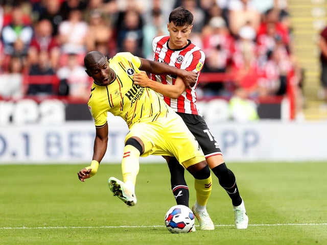 SHEFFIELD, ENGLAND - AUGUST 06: Benik Afobe of Millwall is challenged by Anel Ahmedhodzic of Sheffield United during the Sky Bet Championship match between Sheffield United and Millwall at Bramall Lane on August 06, 2022 in Sheffield, England. (Photo by Cameron Smith/Getty Images)