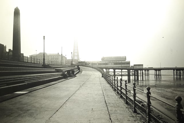 Looking up the slip on the lower promenade towards North Pier. Blackpool Tower is shrouded in mist in this 1983 shot