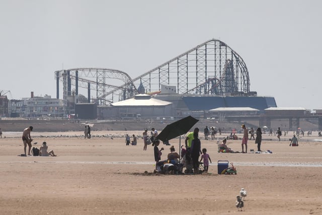Blackpool on the hottest day of the year so far, with the Big One at the Pleasure Beach providing the backdrop as hardy beachgoers take to the scorching sands