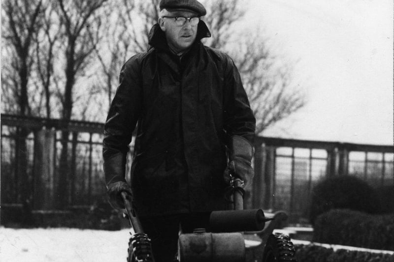 A member of the Blackpool Parks Department operating a mechanical snow plough in Stanley Park