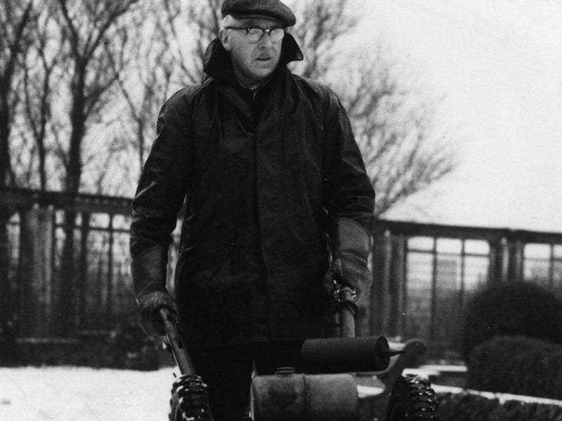 A member of the Blackpool Parks Department operating a mechanical snow plough in Stanley Park