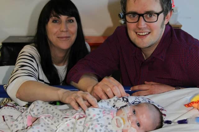 Greg and Jill Johnston with Evie, who died of heart problems