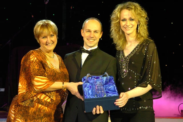 Richard Veal of New Mind presents Jude Rothwell (left) and Misty Nicholson of Blackpool Zoo with the Tourism Website of the Year award, 2006