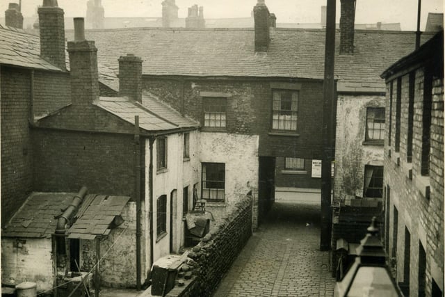 Wilkinson's Yard, looking towards Bonny Street (seen through the archway).The location of the white cottage (on the left) can be seen near the centre of the section enlarged from the original photograph of Central Station (in the archive) . These old streets can be seen in the triangular area between the Promenade and the Central Station platforms in the aerial view of Central Station .