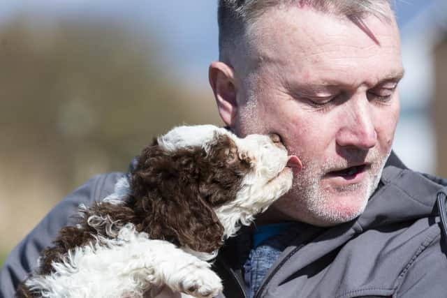 Adam Clark, 51, with his new puppy Ollie