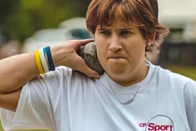 Claire Buckle participating in the shot put