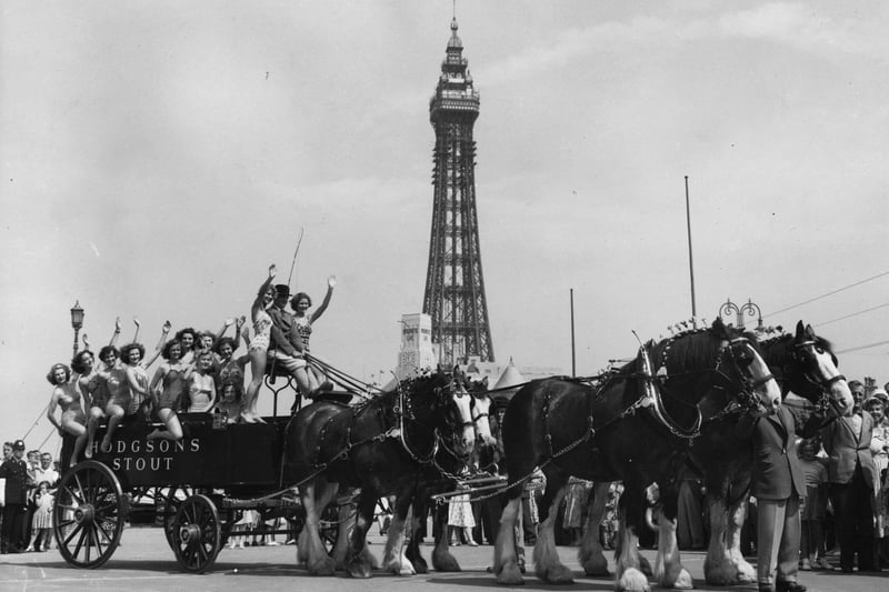A group of bathers getting a lift on a dray pulled by four of London Brewery's Clydesdale Shire horses after arriving in Blackpool for the Royal Show