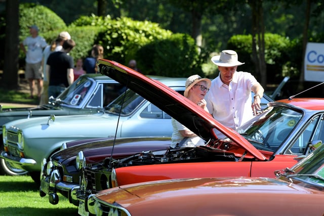 People viewing the shiny old cars at the Classic show on Miller Park, Preston
