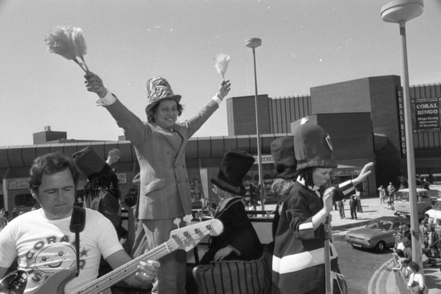 The crowds turned out to see comic Ken Dodd tour Blackpool in an open-topped bus to draw fun-seekers to the resort's brand new £4.5m leisure complex - Coral Island, in the centre of the Golden Mile. Leading his way was a procession of horse-drawn landaus piled high with pretty girls, and a jazz band pounded a holiday beat