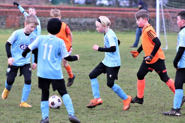 Action from our Blackpool and District Youth Football League match of the week between the Under-9s of YMCA Blues and CN Sports Marvels Picture: B&DYFL