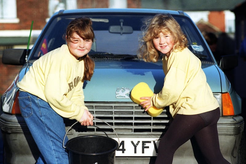 Leanne Thompson and Emma Stamford of the 37th Blackpool Salvation Army Brownies taking part in a sponsored car wash to raise money for their troop, 1996