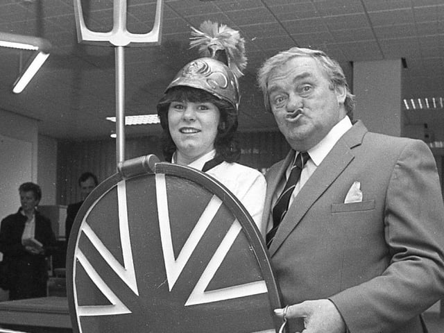 Birthday boy Les Dawson smacked a real "Cosmo kiss" at Britannia as he cut the tape at a seaside savings office. The Lancashire comedian celebrated his 55th birthday as he opened Blackpool's first Britannia building society in Clifton Road. Lucky Britannia - caterer Janet Wilson - stepped into her glad rags while she served food at the celebration opening