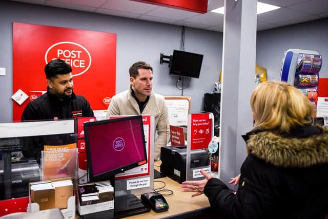 Mr Benton behind the counter at the Blackpool Central post office with postmaster Azim Shaikh.