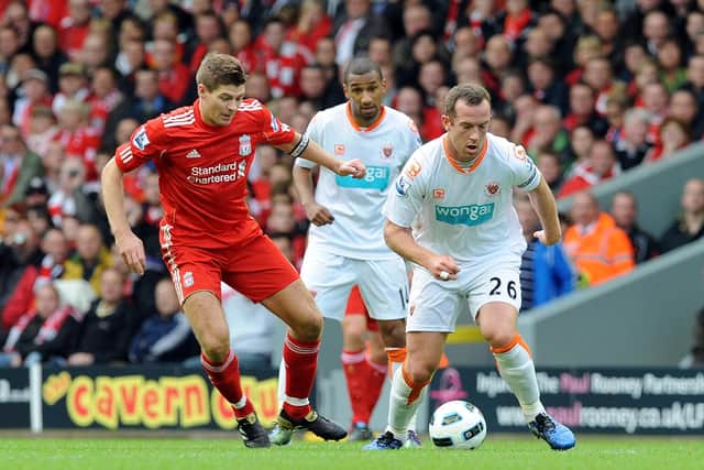 LIVERPOOL, ENGLAND - OCTOBER 03:  (THE SUN OUT) Steven Gerrard of Liverpool goes past Charlie Adam of Blackpool during the Barclays Premier league match between Liverpool and Blackpool at Anfield on October 3, 2010 in Liverpool, England.  (Photo by John Powell/Liverpool FC via Getty Images)