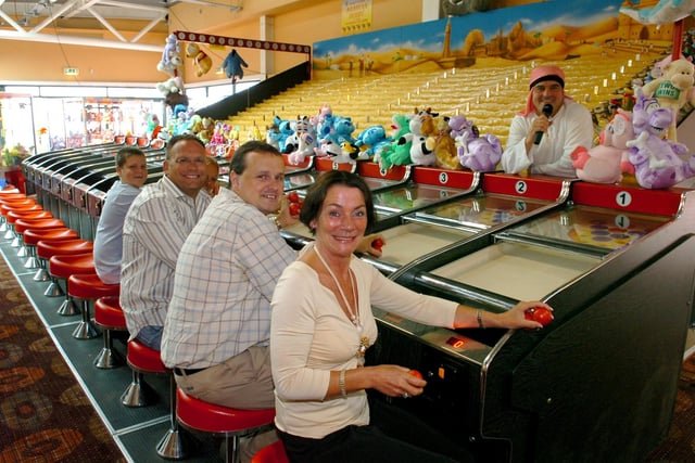 Opening of the Golden Pyramid Amusements building at the former Grab City site.  Trying out the Arabian Derby are Barbara Thompson Shaun Hartley and Andrew Brindley, 2006