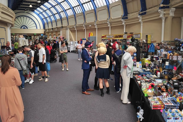 Cosplayers and guests browse the stalls