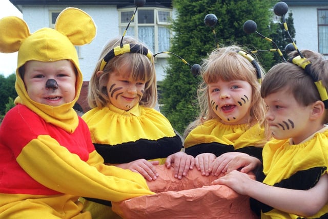 Winnie-the-Pooh and some of his bees delve into the honeypot - (from left) Christopher Everett, Rebecca Robinson and Charlotte Brennan, all aged four, on Garstang's Rainbow Pre School group float at Garstang Children's Festival