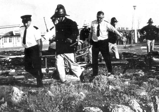 Rescue workers carry a body from the scene