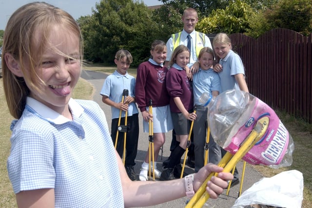 Marton Primary pupil Emma Wright, with school friends and Blackpool Council representatives, cleaning up litter from public areas on Highfield Rd in 2003