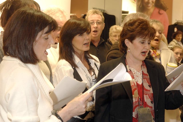 Members of the Nolan Sisters and their family performing Christmas carols at M&S