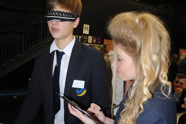 Declan Taylor attempts a Bushtucker Trial-style test, assisted by Kayleigh Rothery ahead of their two schools, Bispham High and Collegiate merging