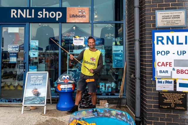 John Chamley makes sure the RNLI shop front looks it best for the event. Picture: Alan Hunter.