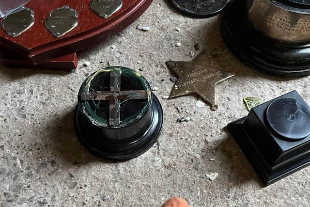 Trophy bases left behind after intruders ripped off the metal cups during the break-in