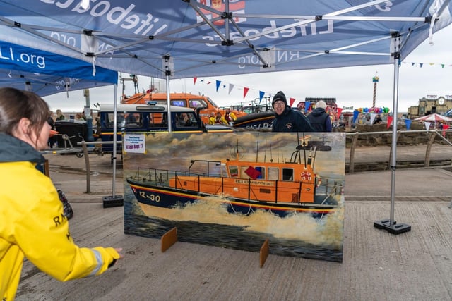 Throwing a bean bag through a lifeboat window was among the many fun games at the event. Picture: Alan Hunter.
