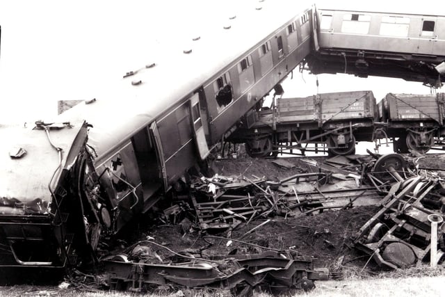 'Coaches of the boat train rear into the air high above wagons of a ballast train , after the rail crash at Weeton' - published July 17 1961